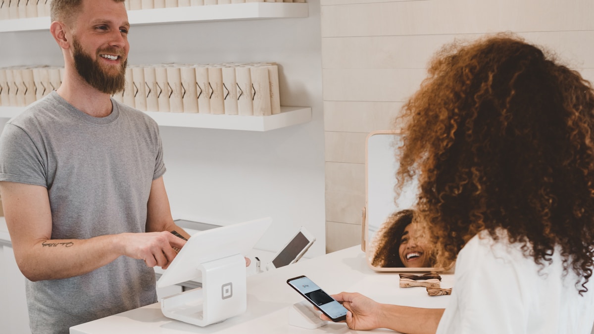 Retail entrepreneur using tablet to manage multiple store sales remotely